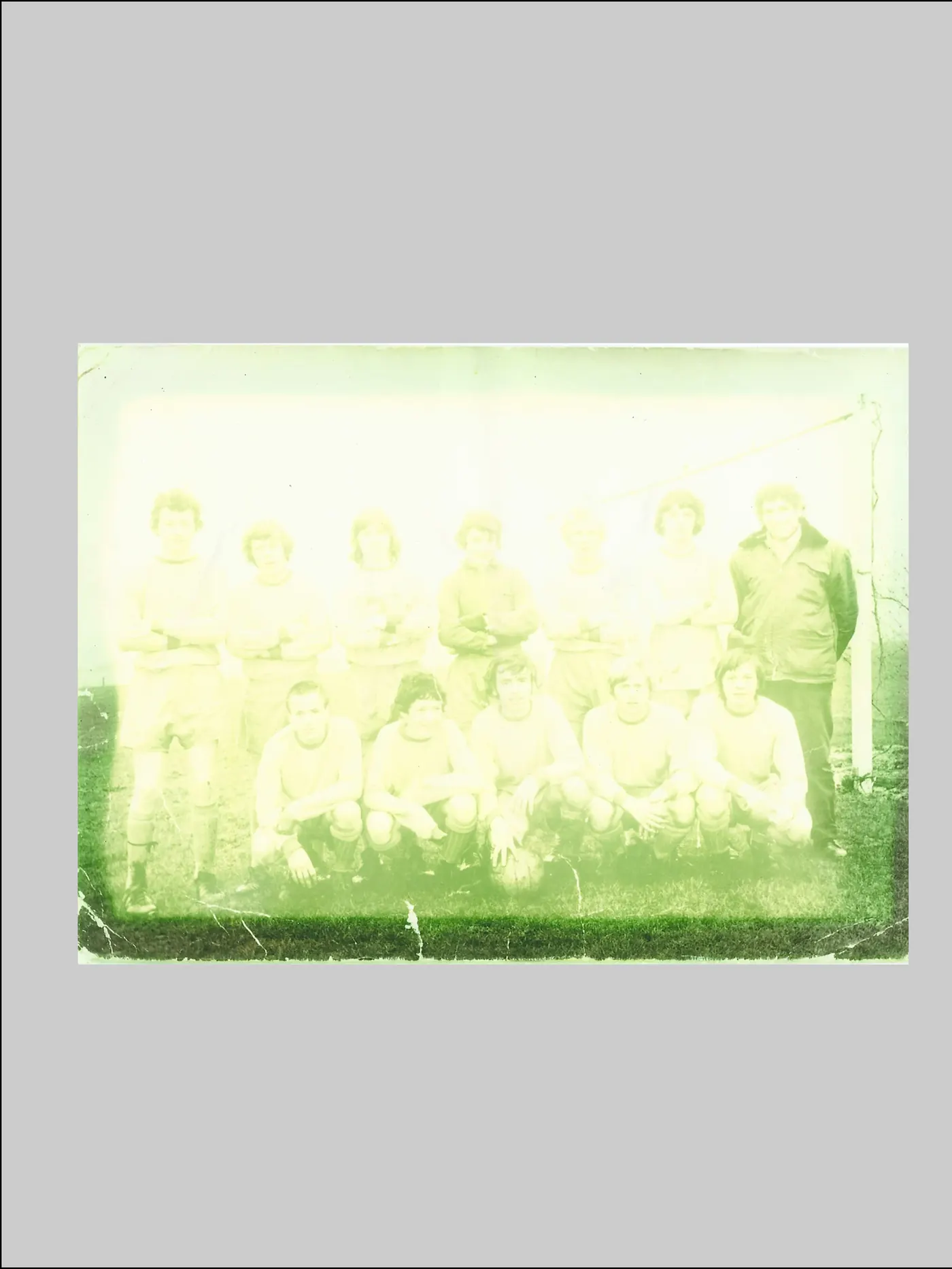 Team photograph before restoration, showing heavy damage